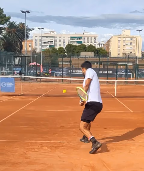 Tennis player preparing to return a ball.